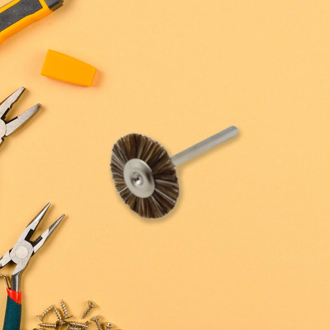 A shank-mounted brass wire brush, ideal as a drill attachment for metal grinding.