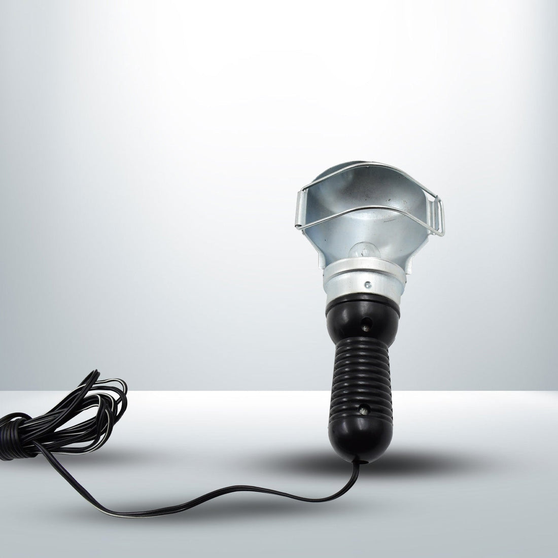The Portable Work Lamp placed on a surface, highlighting its stable base.