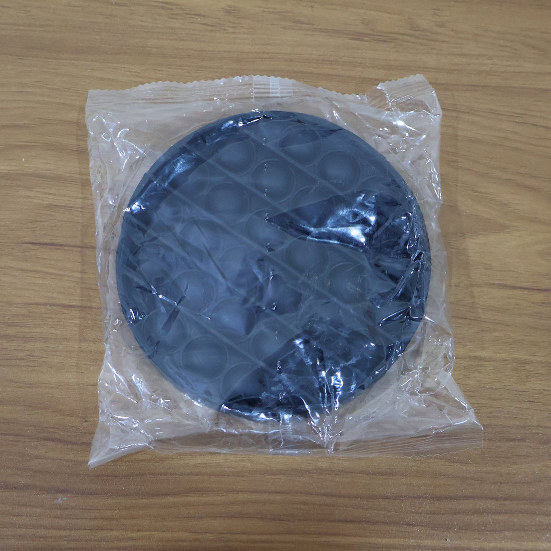 Back view of round silicone Pop It fidget toy for sensory play