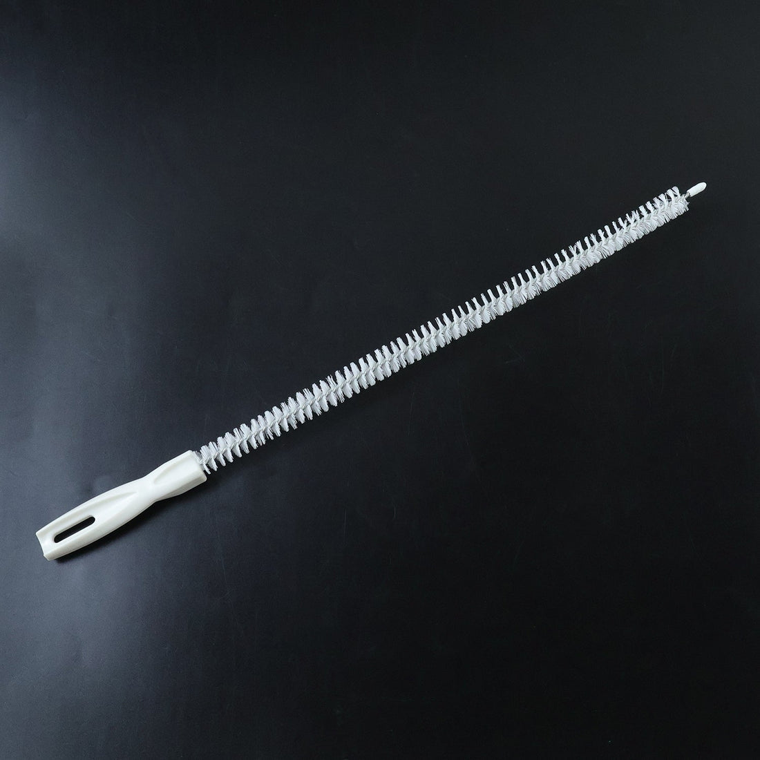 Flexible long brush cleaning a kitchen sink drain