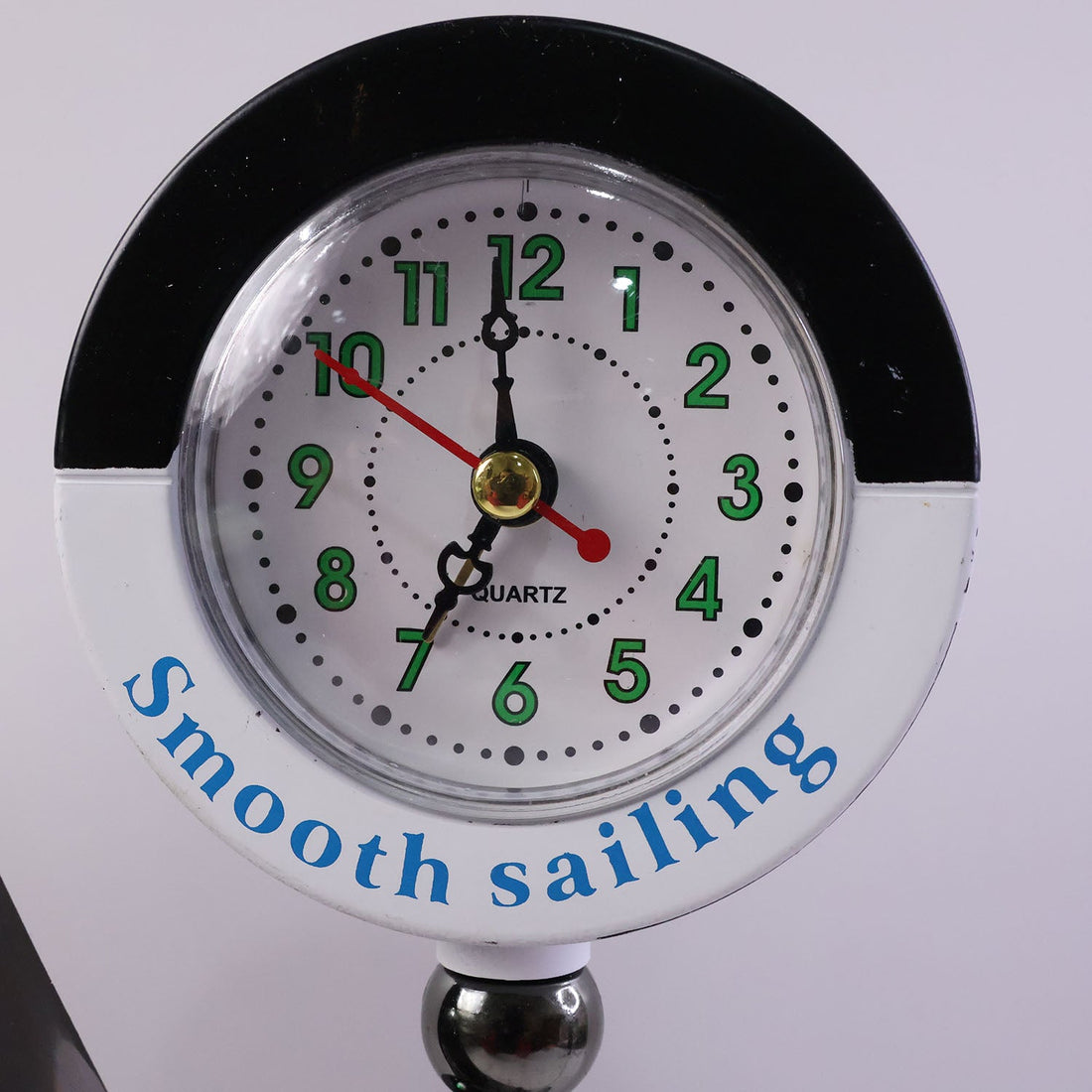 Ship shape clock lamp lit on table showing warm LED ambiance
