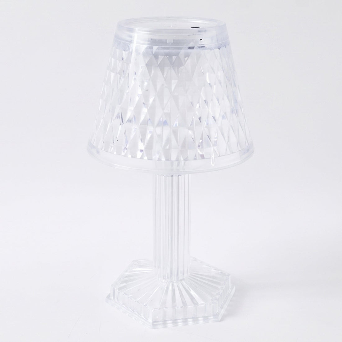 Modern LED crystal lamp displayed on a wooden shelf in a home setting.